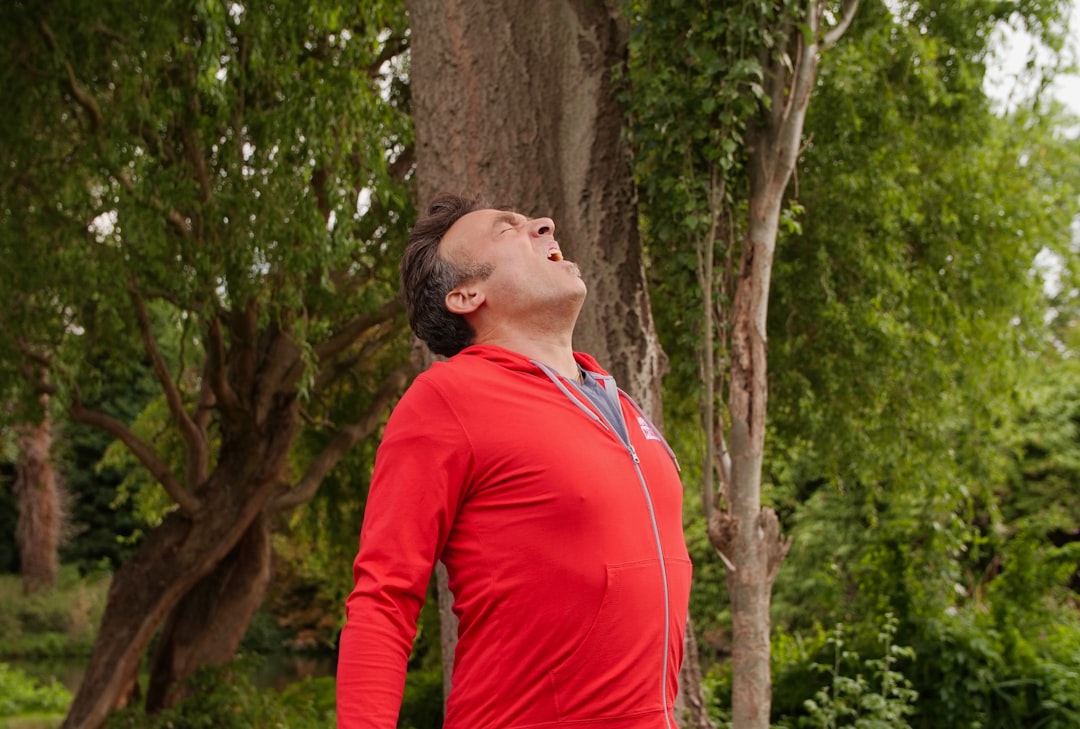 Athlete practicing breathing exercise with respiratory training equipment