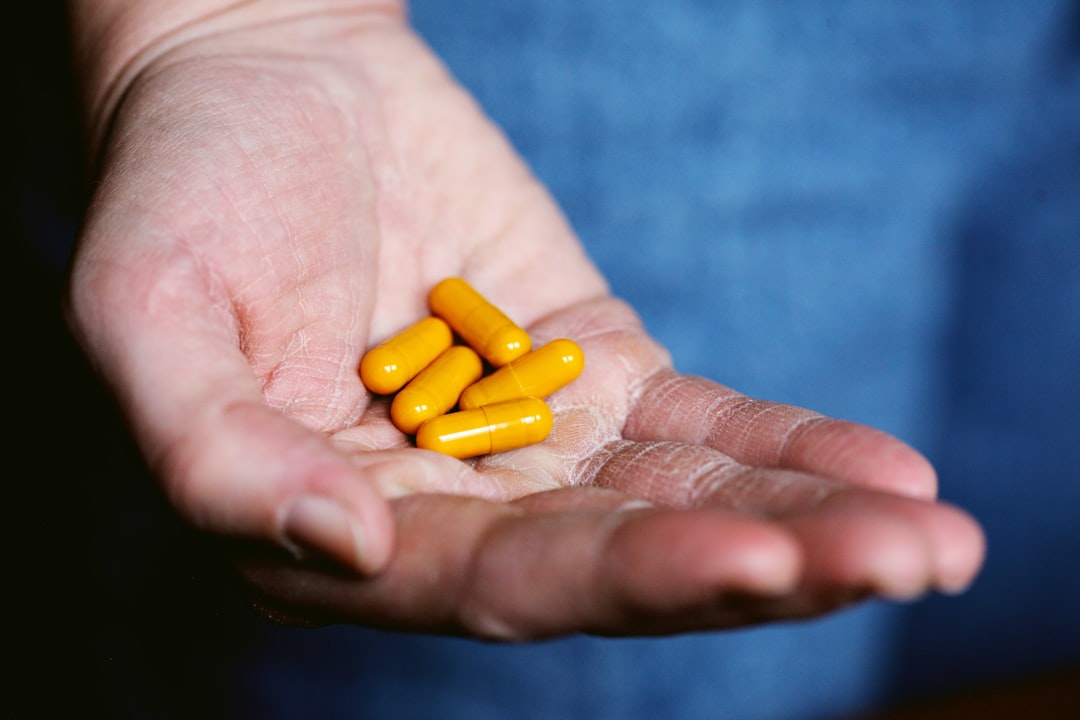 Person taking supplement capsule for health and wellness