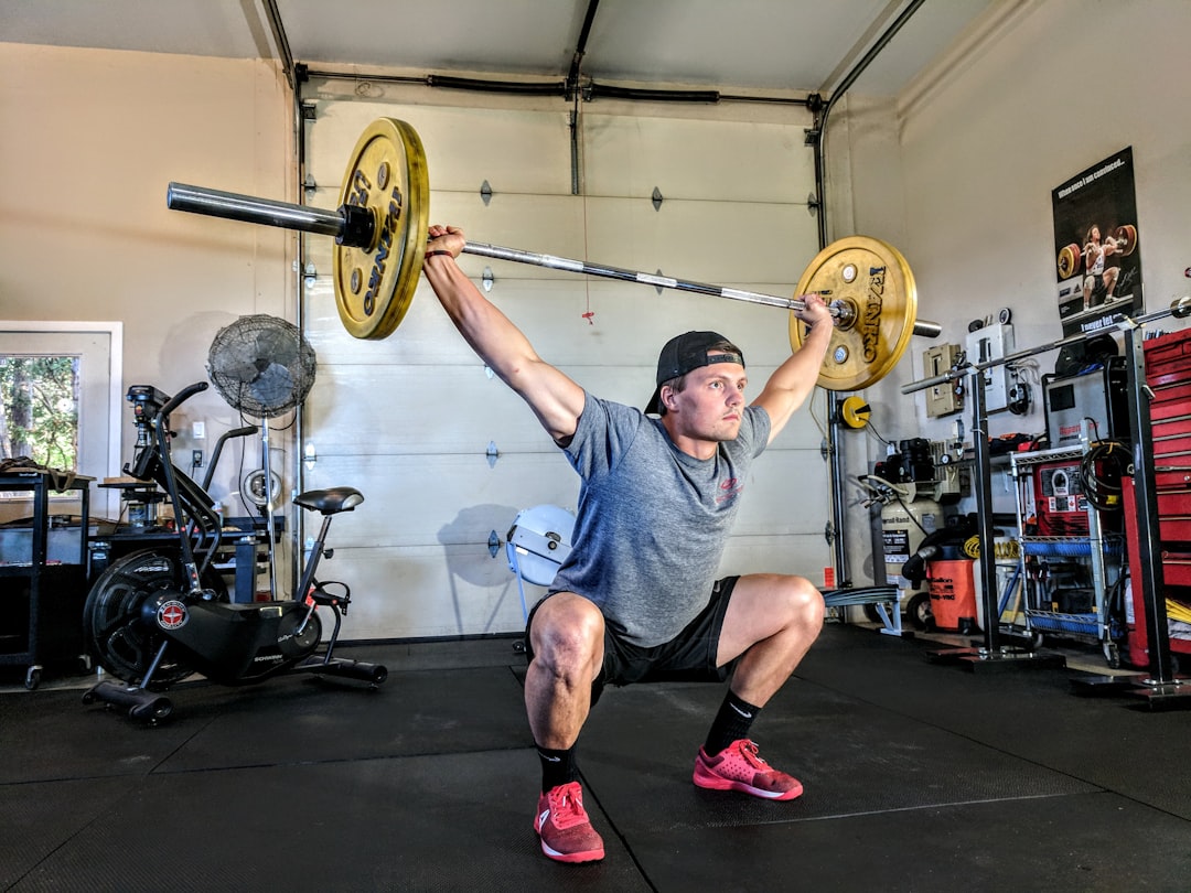 Man lifting barbell with control