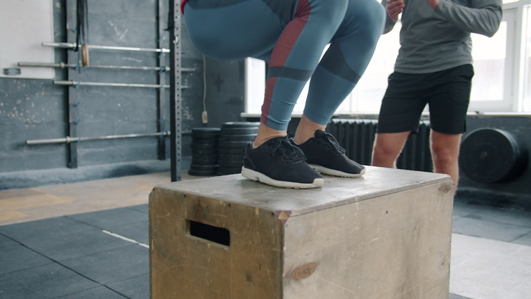 Athlete performing functional fitness training with kettlebell in gym