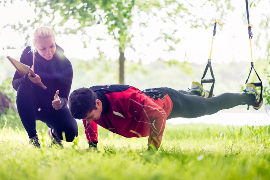 {{ locale === 'ar' ? 'مدرب يساعد في الوقاية من الإصابات' : 'Trainer helping with injury prevention' }}