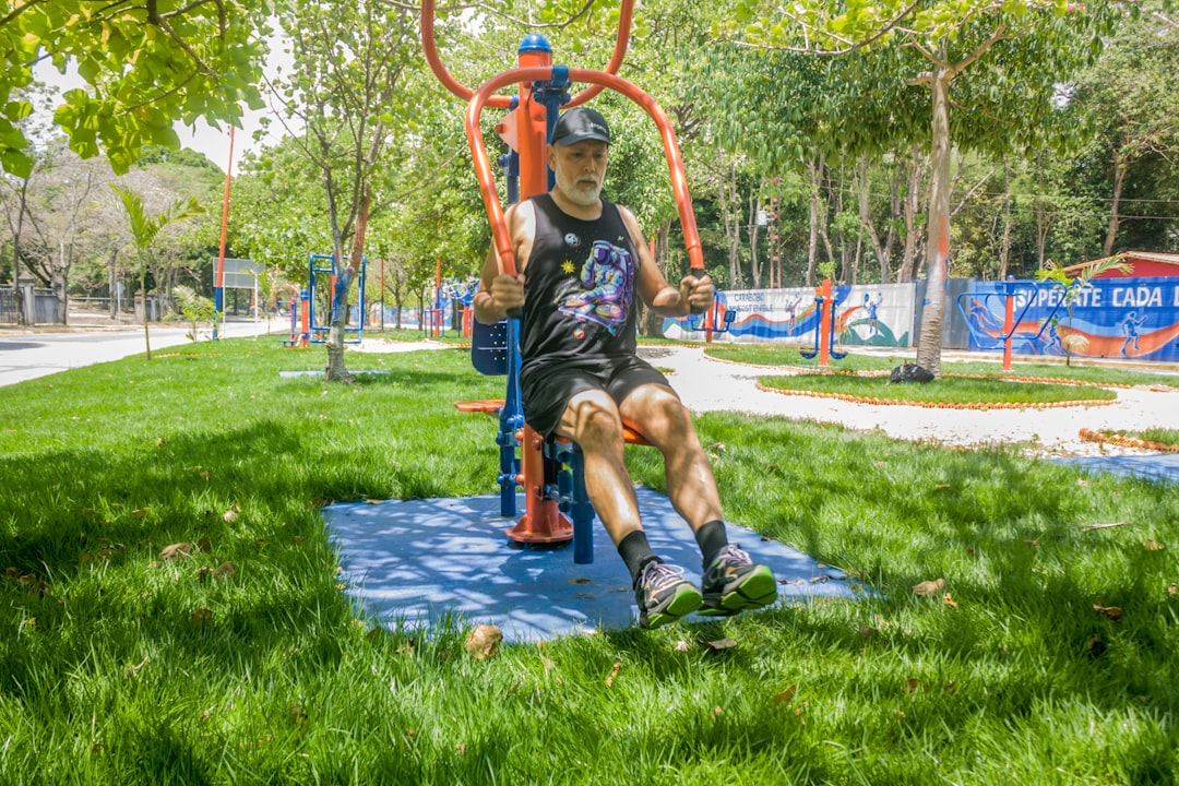 Man exercising on outdoor gym equipment