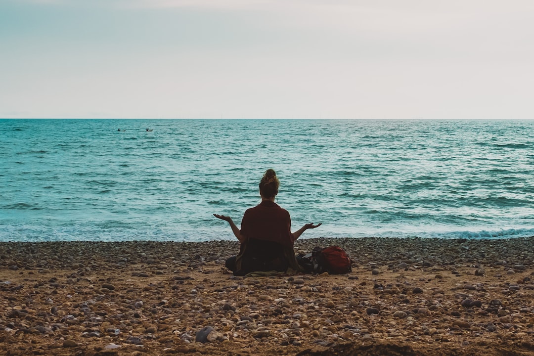 Person meditating practicing mindfulness and awareness