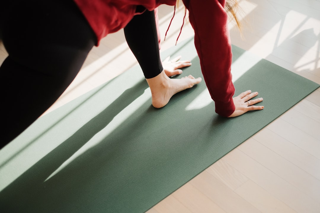 Person practicing yoga and mobility training on mat