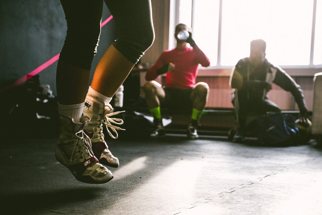 Person performing squat jump plyometric exercise for explosive leg power