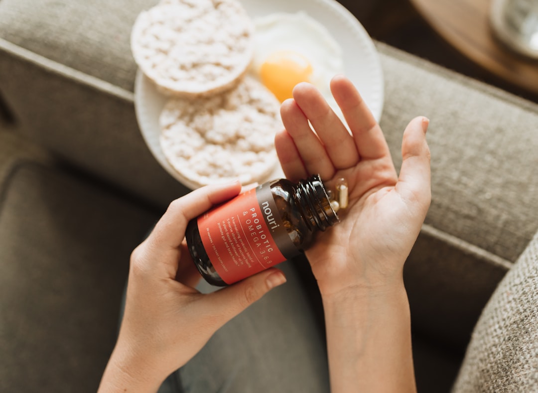 Person holding pre workout supplement bottle