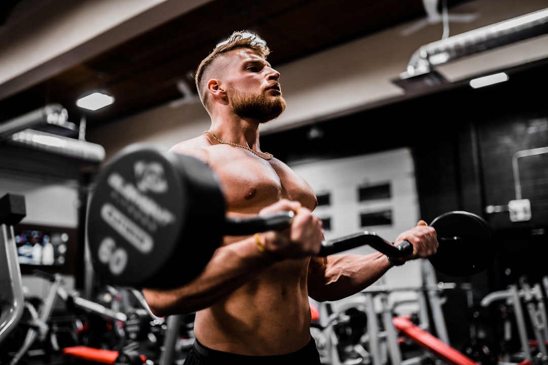 Strong athlete with dumbbells showing muscle strength and bone health