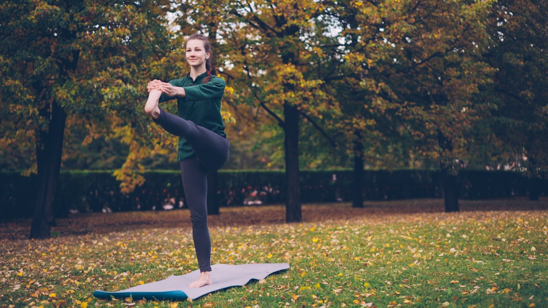 Woman practicing yoga pose outdoors in nature