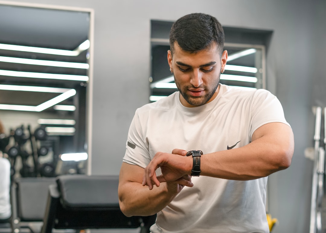 Person wearing fitness tracker during gym workout